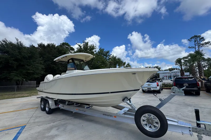 Slide: The Image of 2027 Chris-Craft Catalina 28 boat on trailer under blue sky. - 8