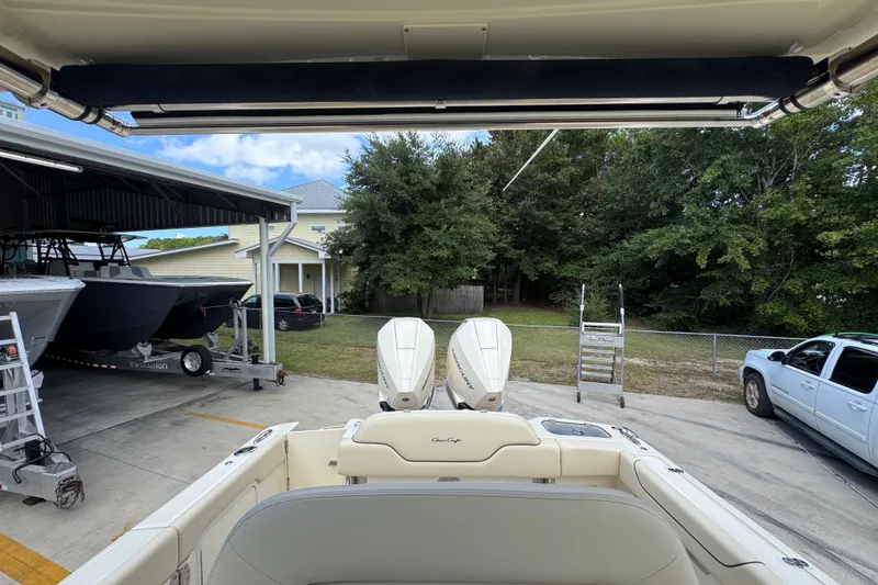Slide: The Image of 2027 Chris-Craft Catalina 28 boat docked, featuring dual engines and a covered storage area. - 32