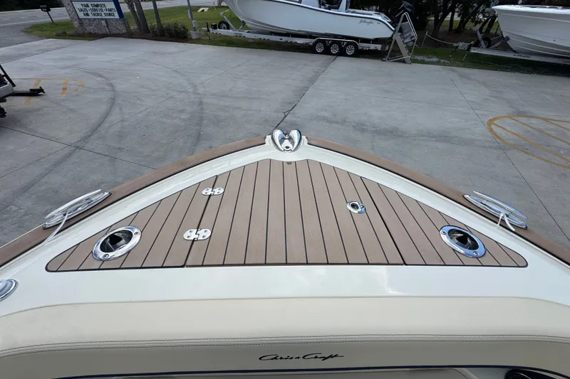 Slide: The Image of 2027 Chris-Craft Catalina 28 boat deck with wood finish, parked on concrete. - 23