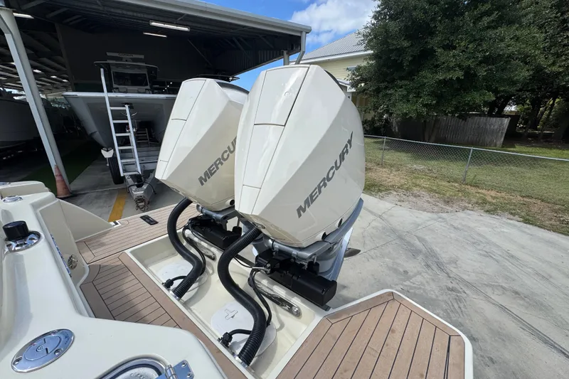 Slide: The Image of 2027 Chris-Craft Catalina 28 with dual Mercury outboard engines, docked outdoors. - 44