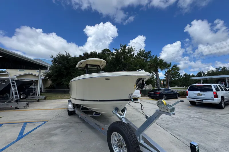 Slide: The Image of 2027 Chris-Craft Catalina 28 boat on trailer under a blue sky with clouds. - 7