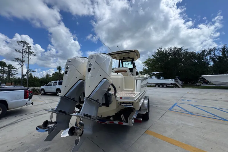 Slide: The Image of 2027 Chris-Craft Catalina 28 boat with dual outboard engines in a parking lot. - 15