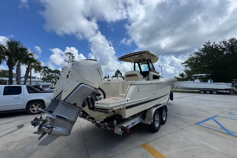 Slide: The Image of 2027 Chris-Craft Catalina 28 boat on trailer, parked outdoors under a cloudy sky. - 14