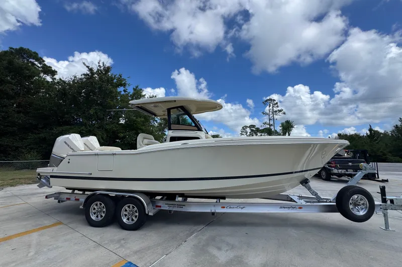 Slide: The Image of 2027 Chris-Craft Catalina 28 boat on trailer under blue sky. - 10