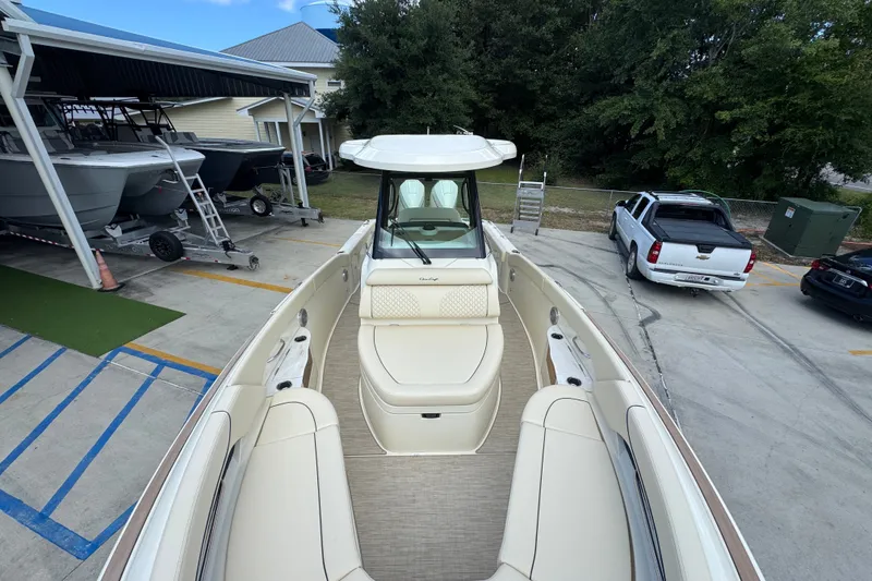 Slide: The Image of 2027 Chris-Craft Catalina 28 boat with elegant seating, parked in a marina. - 25
