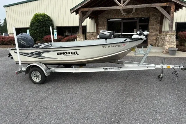 The Image of 2026 Smoker Craft Angler 16 T boat on trailer, parked outside a building. - 0
