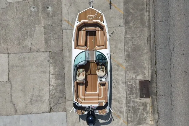 Slide: The Image of Overhead view of 2025 NauticStar 243 DC Deck boat on concrete surface. - 1