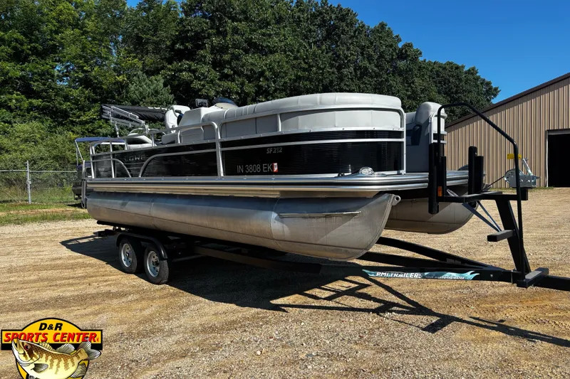 The Image of 2022 Lowe SF 212 Sport Fish pontoon boat on trailer, parked outdoors. - 0