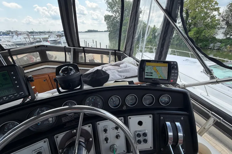Slide: The Image of Interior view of 1989 Carver 3607 Aft Cabin Motor Yacht helm with navigation equipment. - 16