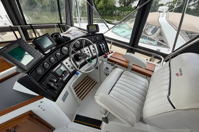 Slide: The Image of Helm of 1989 Carver 3607 Aft Cabin Motor Yacht with navigation instruments and captain's chair. - 13