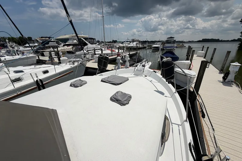 Slide: The Image of 1989 Carver 3607 Aft Cabin Motor Yacht docked at marina under cloudy sky. - 7