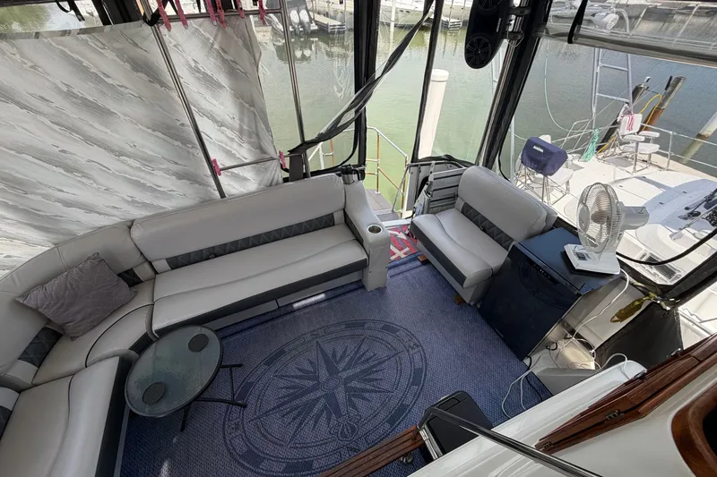 Slide: The Image of 1989 Carver 3607 Aft Cabin Motor Yacht interior with seating, table, and fan. - 12