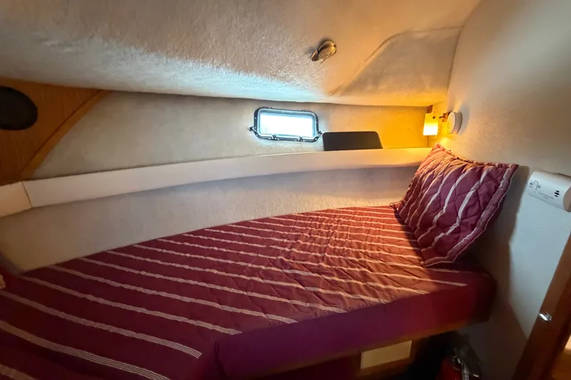 Slide: The Image of Cozy cabin interior of 1989 Carver 3607 Aft Cabin Motor Yacht with striped bedding. - 31