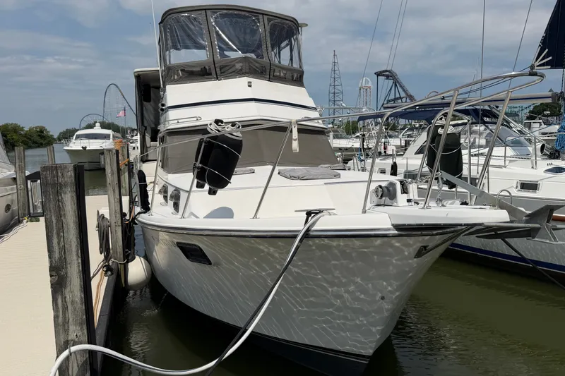 Slide: The Image of 1989 Carver 3607 Aft Cabin Motor Yacht docked at marina under clear sky. - 2
