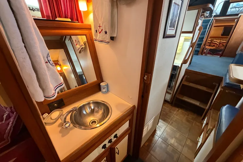 Slide: The Image of 1989 Carver 3607 Aft Cabin Motor Yacht interior with sink and wooden cabinetry. - 35