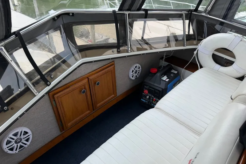 Slide: The Image of 1989 Carver 3607 Aft Cabin Motor Yacht interior with seating, storage, and life preserver. - 17
