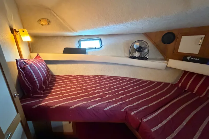 Slide: The Image of Cozy cabin interior of 1989 Carver 3607 Aft Cabin Motor Yacht with striped bedding. - 30
