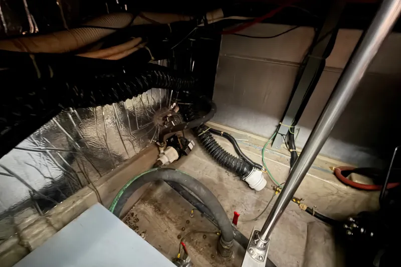 Slide: The Image of Engine room of 1989 Carver 3607 Aft Cabin Motor Yacht with visible hoses and wiring. - 55