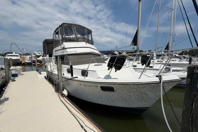Slide: The Image of 1989 Carver 3607 Aft Cabin Motor Yacht docked at marina under blue sky. - 4