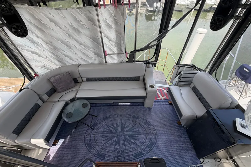 Slide: The Image of Interior of 1989 Carver 3607 Aft Cabin Motor Yacht with plush seating and nautical decor. - 11