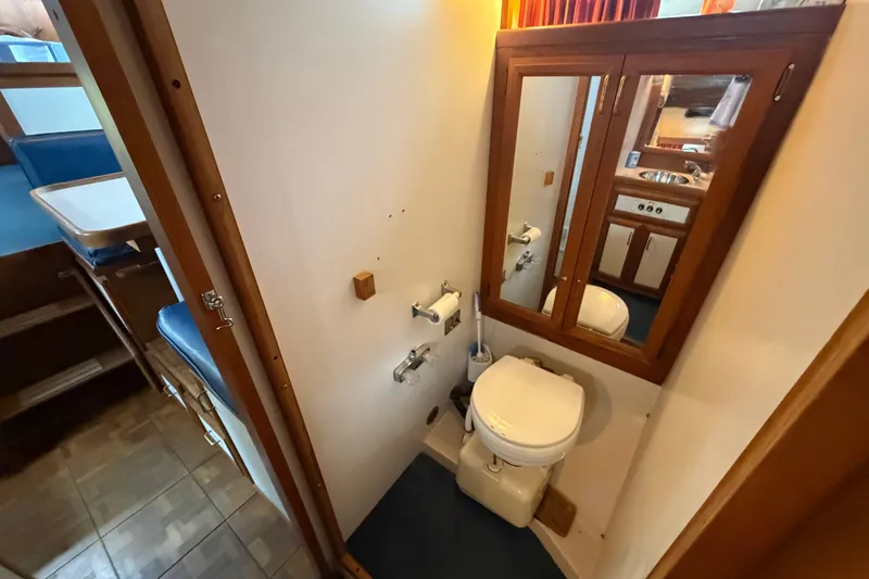 Slide: The Image of 1989 Carver 3607 Aft Cabin Motor Yacht bathroom with mirror and toilet. - 34