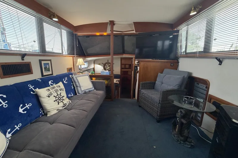 Slide: The Image of Interior of 1989 Carver 3607 Aft Cabin Motor Yacht with cozy seating and nautical decor. - 19