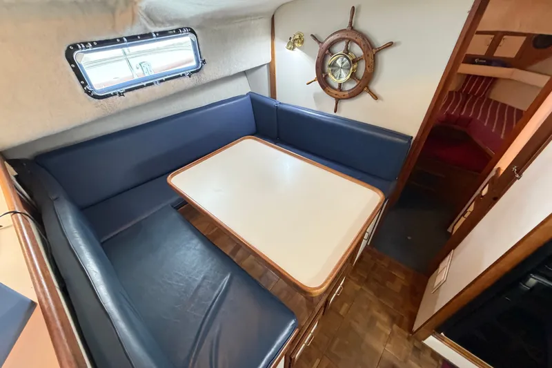 Slide: The Image of 1989 Carver 3607 Aft Cabin Motor Yacht interior with dining area and nautical decor. - 23