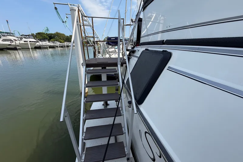 Slide: The Image of 1989 Carver 3607 Aft Cabin Motor Yacht docked with boarding stairs. - 9