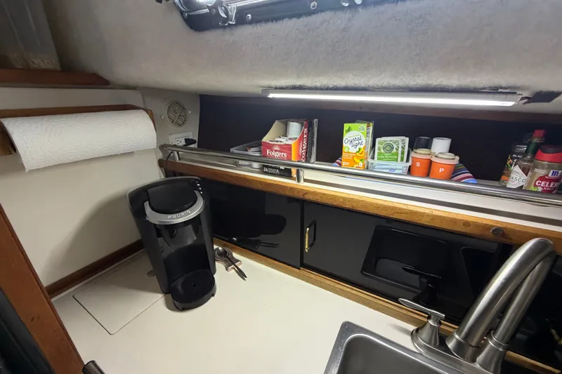 Slide: The Image of Compact galley kitchen in 1989 Carver 3607 Aft Cabin Motor Yacht with coffee maker and supplies. - 27