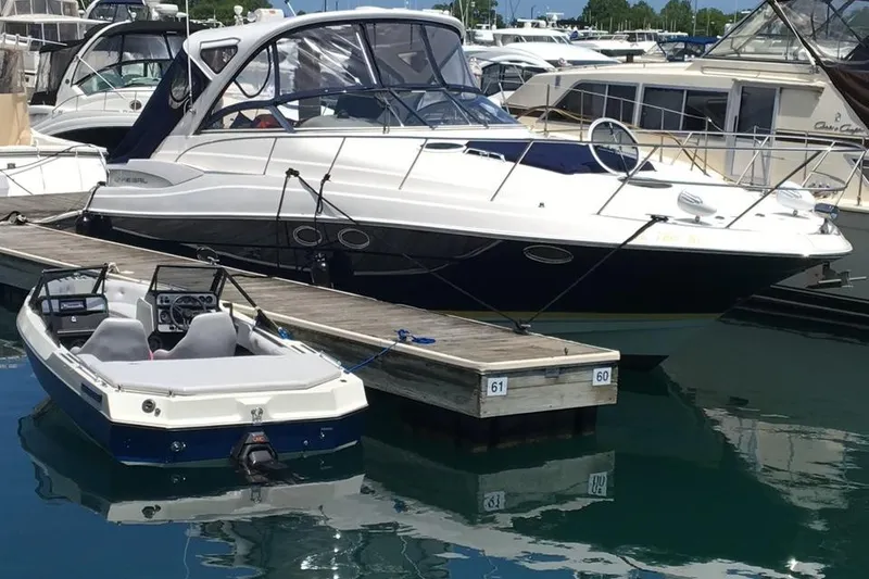 Slide: The Image of 2008 Regal 3760 yacht docked at marina with smaller boat nearby. - 1