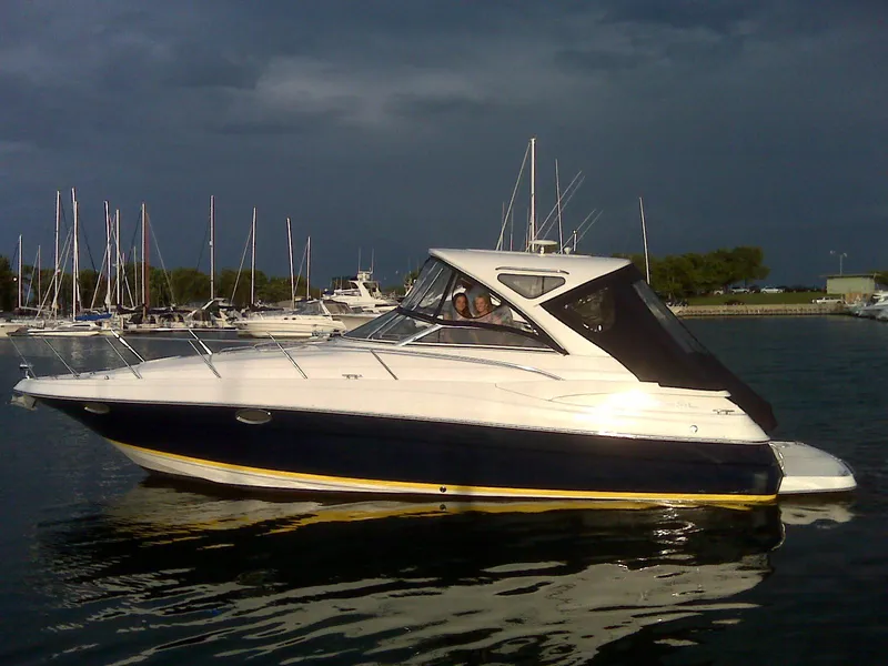 The Image of 2008 Regal 3760 boat on water with marina background. - 0