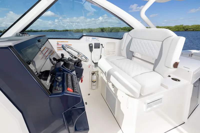 Slide: The Image of 2026 Pursuit DC 326 Dual Console boat interior with modern helm and luxurious seating. - 15