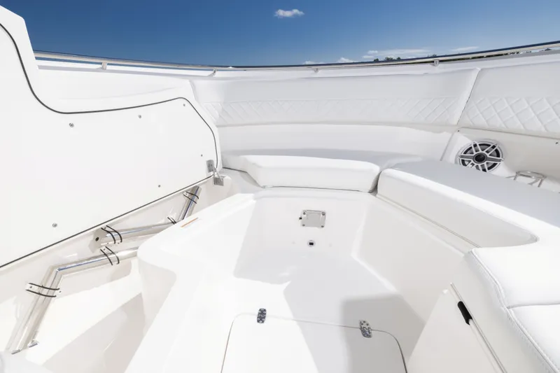 Slide: The Image of 2026 Pursuit DC 326 Dual Console boat interior with white seating and speaker. - 11