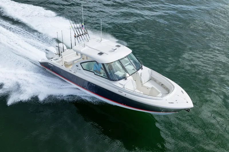 Slide: The Image of 2026 Pursuit DC 326 Dual Console boat cruising on open water. - 5