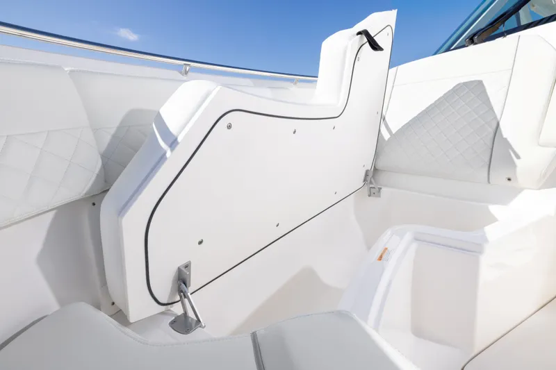 Slide: The Image of 2026 Pursuit DC 326 Dual Console interior with white seating and sleek design. - 10