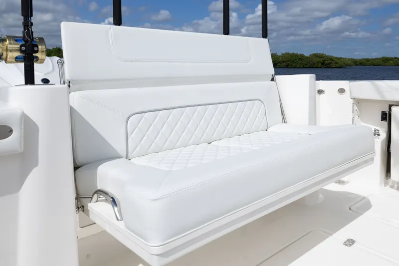 Slide: The Image of 2026 Pursuit DC 326 Dual Console boat with luxurious white seating and quilted design. - 18