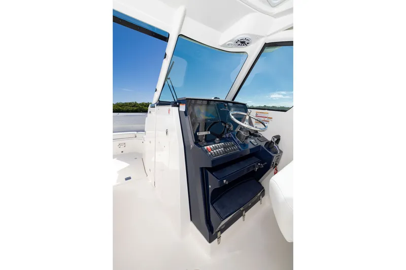 Slide: The Image of Helm of 2026 Pursuit DC 326 Dual Console boat with modern controls and steering wheel. - 14