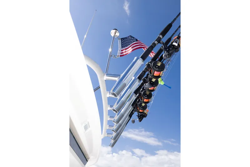 Slide: The Image of Fishing rods on a 2026 Pursuit DC 326 Dual Console boat with American flag. - 23