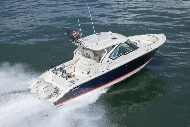 Slide: The Image of 2026 Pursuit DC 326 Dual Console boat cruising on open water. - 3