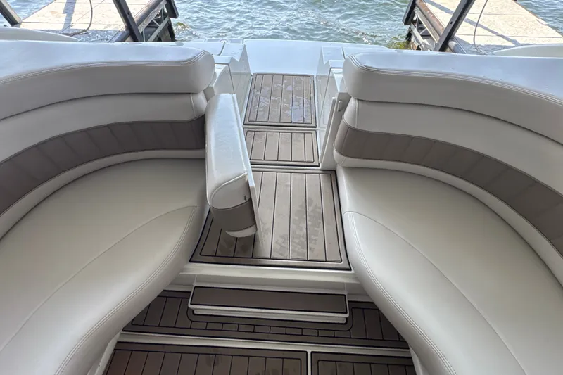 Slide: The Image of Interior view of a 2002 Regal 2900 LSR boat with white seating and wooden flooring. - 21