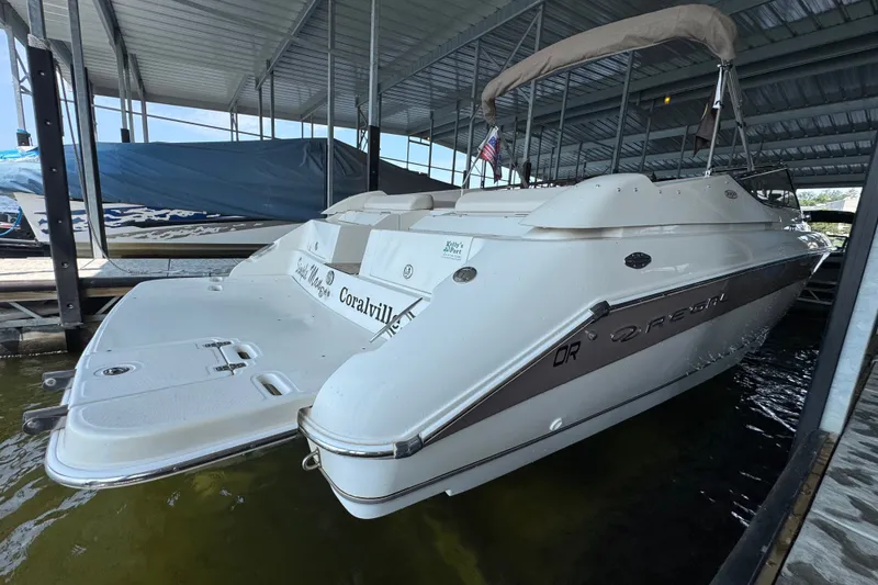 Slide: The Image of 2002 Regal 2900 LSR boat docked under a covered marina. - 44