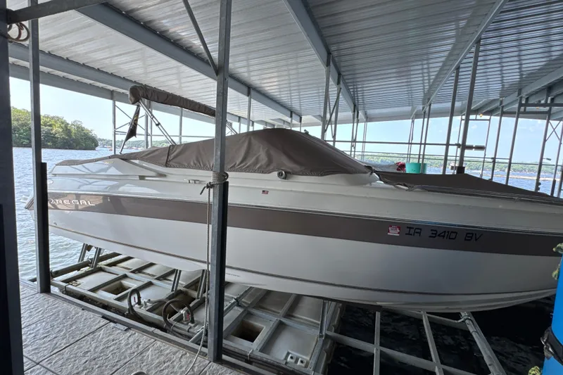 The Image of 2002 Regal 2900 LSR boat docked under a covered marina. - 0
