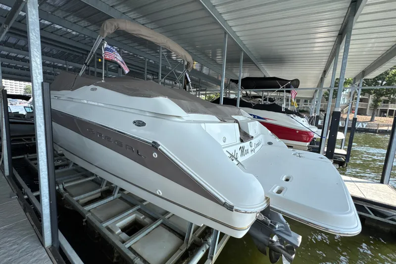 Slide: The Image of 2002 Regal 2900 LSR boat docked under a covered marina. - 3