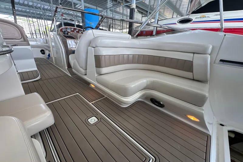 Slide: The Image of Interior of a 2002 Regal 2900 LSR boat with elegant seating and wood flooring. - 24