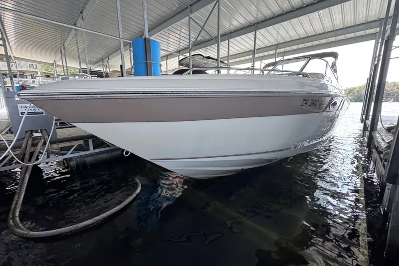 Slide: The Image of 2002 Regal 2900 LSR boat docked under a covered marina. - 5