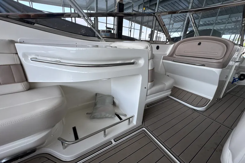 Slide: The Image of Interior of a 2002 Regal 2900 LSR boat with white seating and sleek design. - 15