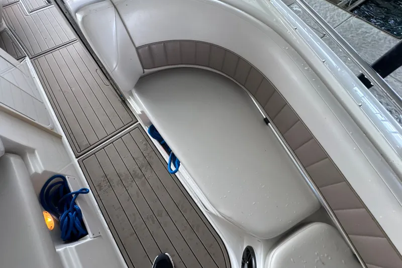 Slide: The Image of 2002 Regal 2900 LSR boat interior with cushioned seating and wooden flooring. - 28