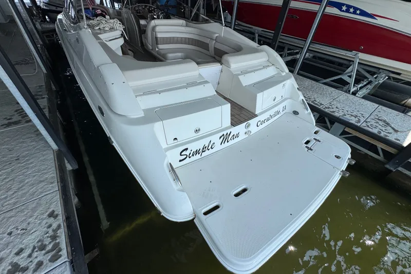 Slide: The Image of 2002 Regal 2900 LSR boat docked, featuring spacious seating and swim platform. - 45