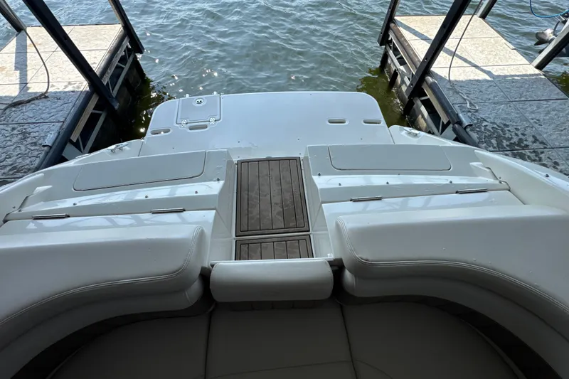 Slide: The Image of 2002 Regal 2900 LSR boat stern view at dock, featuring swim platform and seating. - 30
