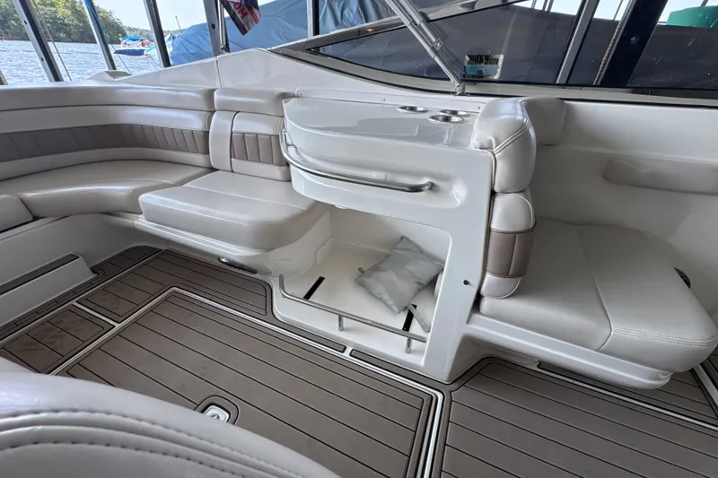 Slide: The Image of Interior of a 2002 Regal 2900 LSR boat with white seating and wood flooring. - 14
